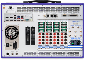 Back view of an electronic testing device with multiple input/output ports, switches, connectors, data slots, power supply modules, cooling fan, and various labeled panels and terminals.